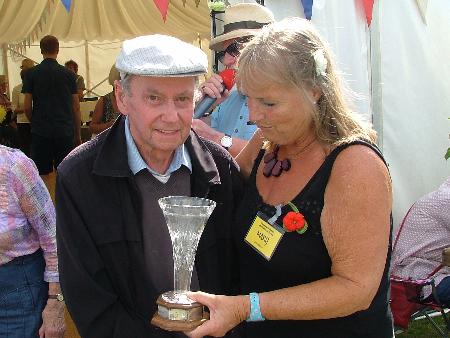 Mary presents Sid Smith with his trophy