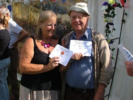 Mary presents Derek Parks with his medal cards